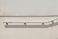 Minimalist White Railing Shadow on Wall