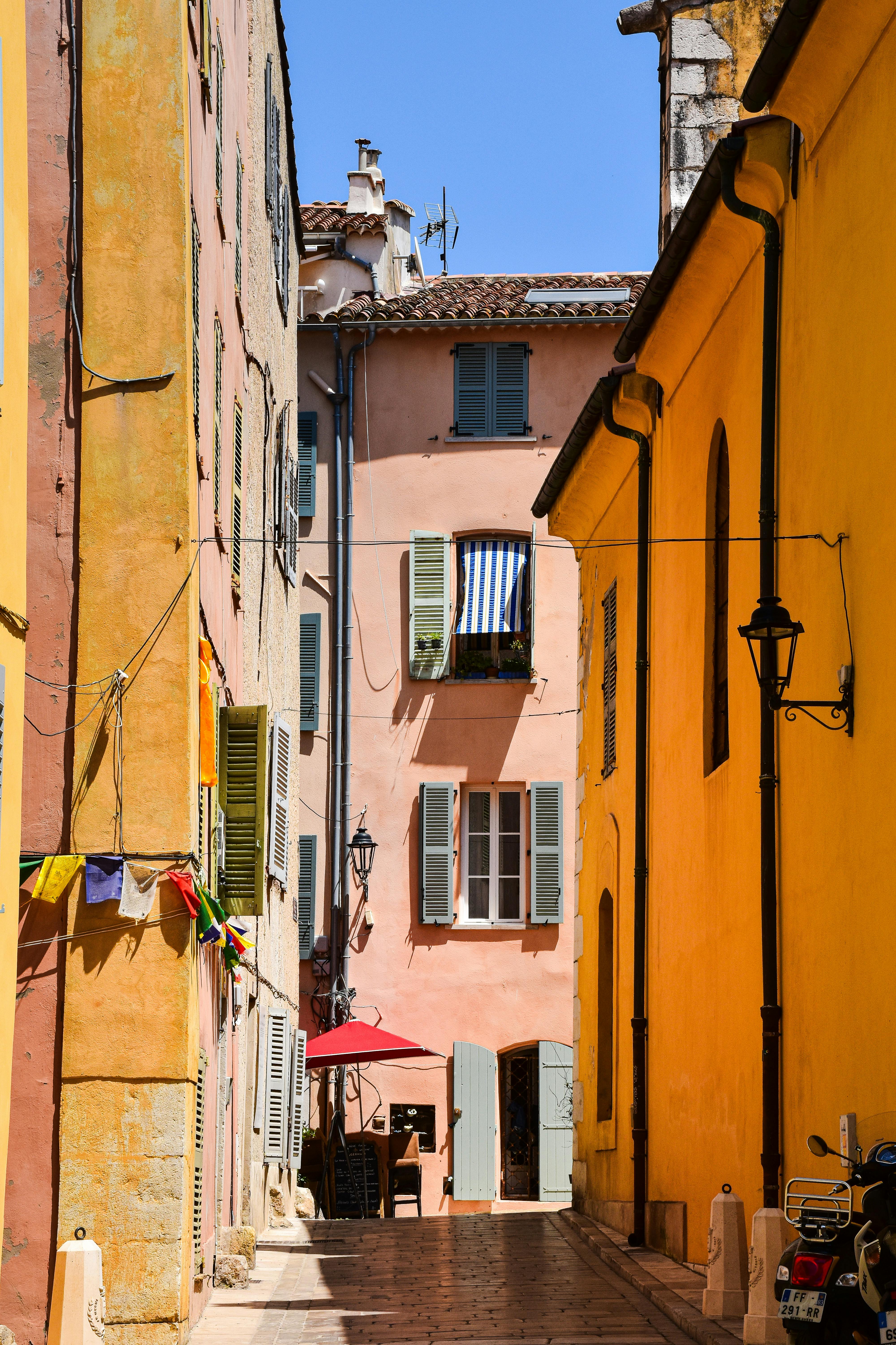 Vibrant alleyway with colorful buildings in Provence-Alpes-Côte d'Azur, France.