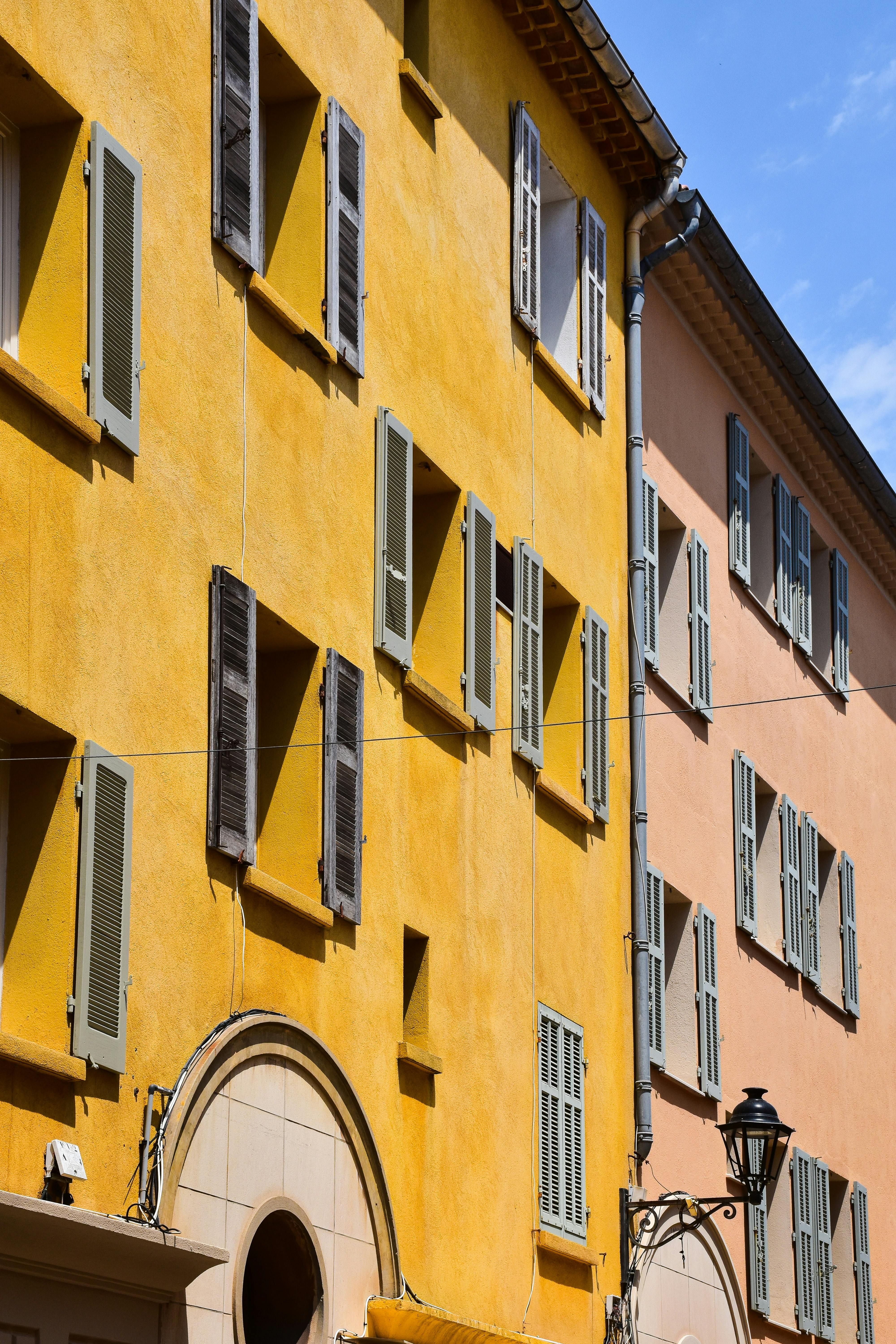 Vibrant yellow and orange building facades in Provence-Alpes-Côte d'Azur, France, showcasing classic French architecture.