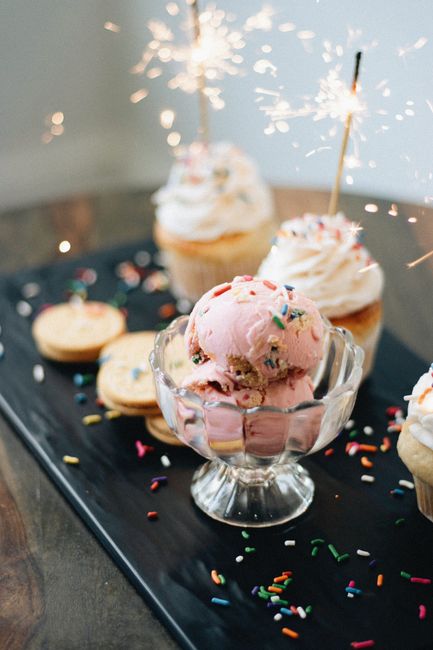 Stylish artisan dessert display featuring strawberry ice cream and sparkling cupcakes.