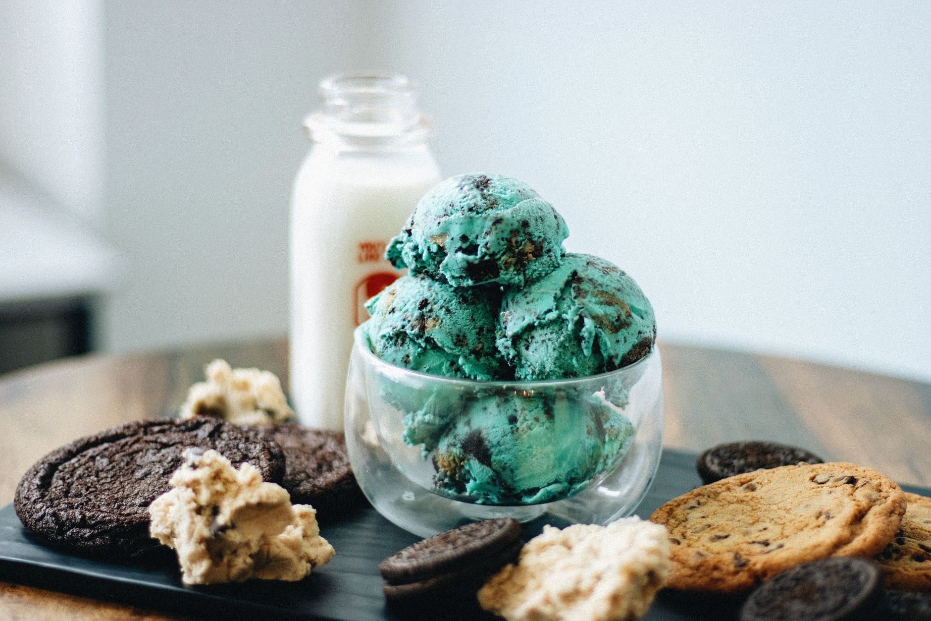Elegant serving of mint cookie ice cream with chocolate drizzle in glass bowl