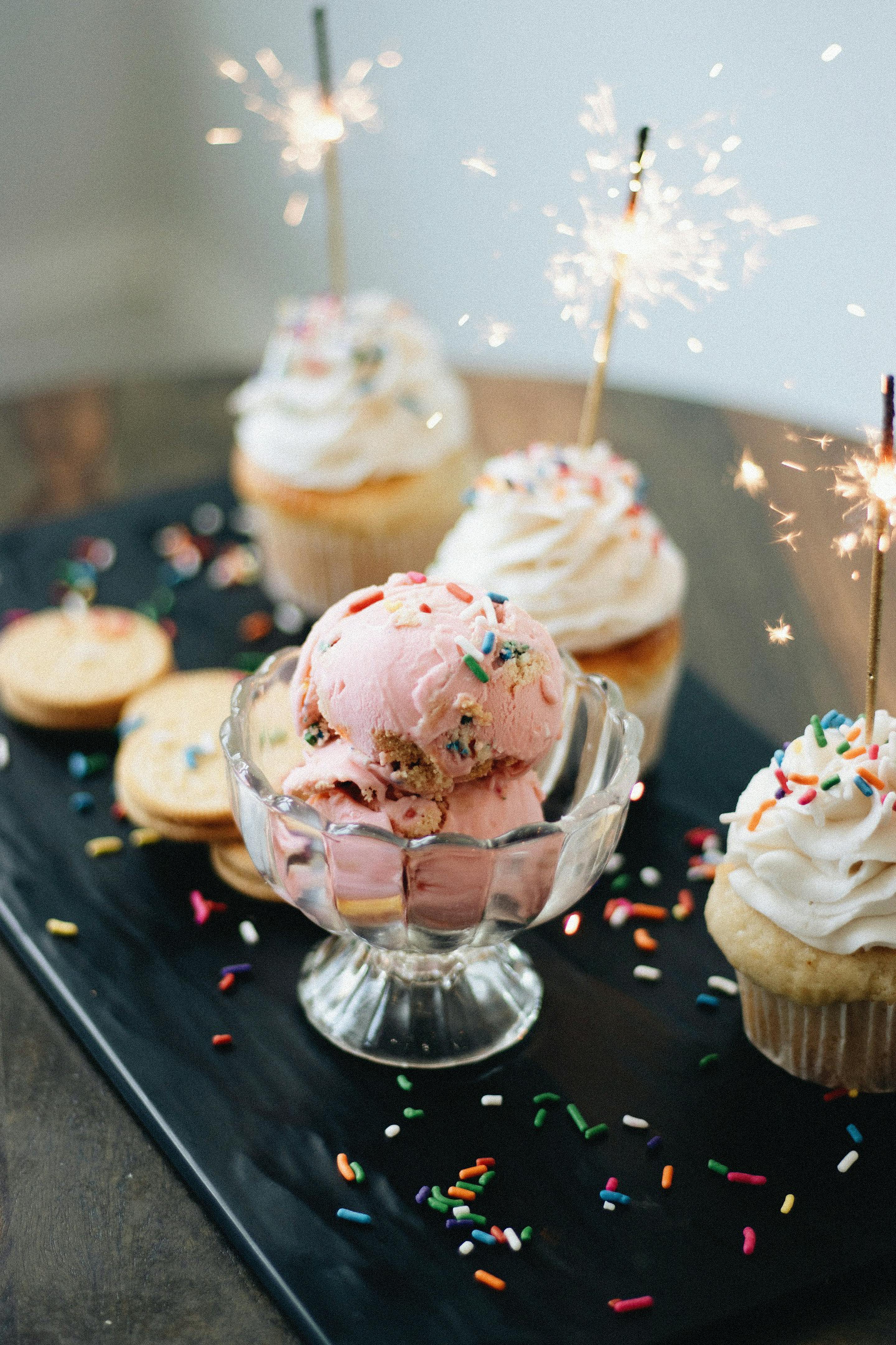 Celebrate with delicious artisanal ice cream and cupcakes decorated with sparklers and sprinkles.