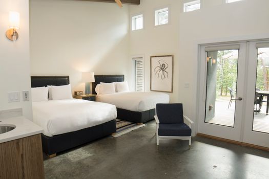 Inviting bedroom with twin beds and contemporary design in Hampton Bays, New York.