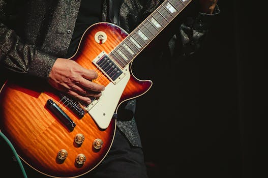 Detailed close-up of guitarist playing a Les Paul at a live concert in Tlaxcala, México.