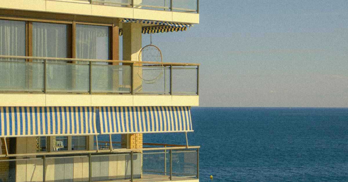Coastal Apartment with Ocean View and Palm · Free Stock Photo