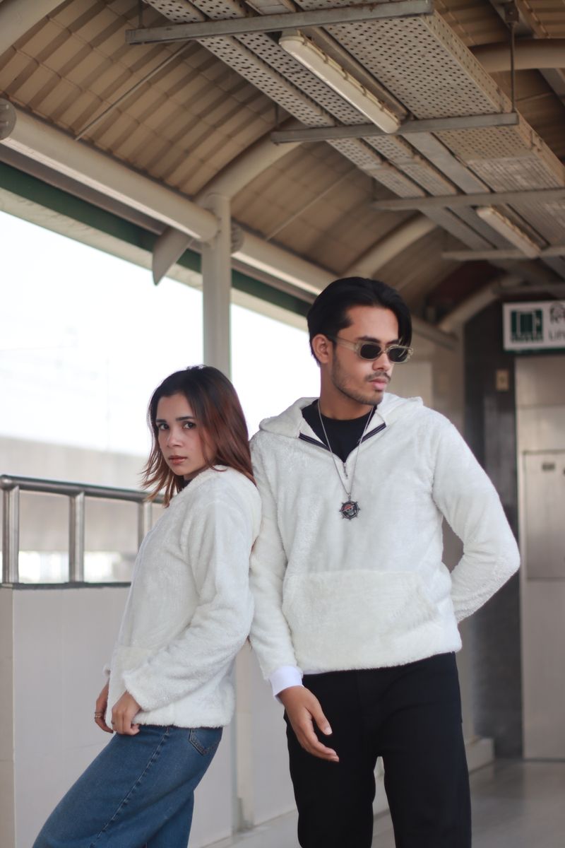 Couple in coordinated white outfits in the city
