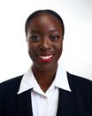 Confident African woman in black suit and white blouse. Ideal for business presentations.