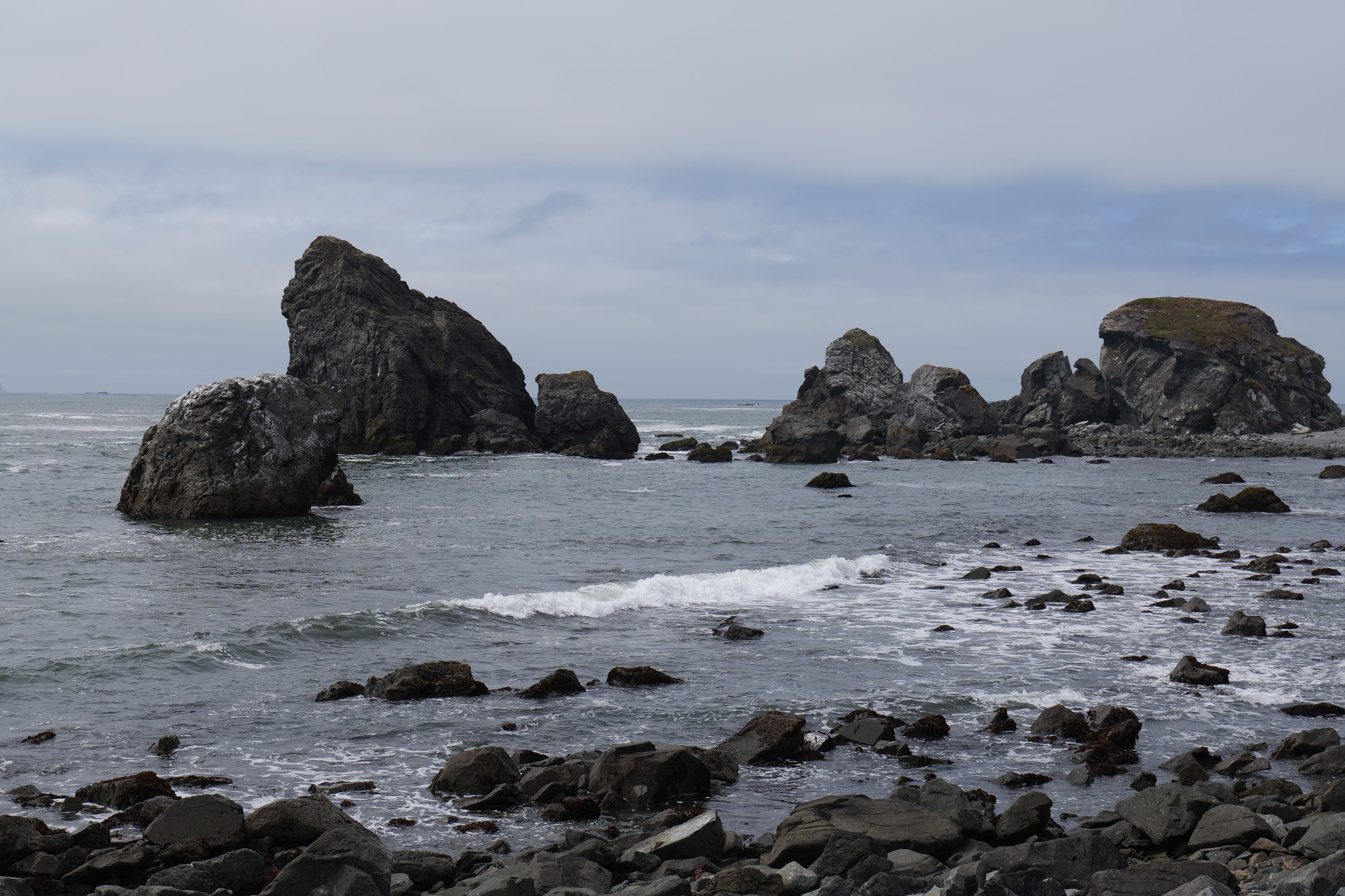 Coastal Rock Formations Against an Overcast Sky · Free Stock Photo