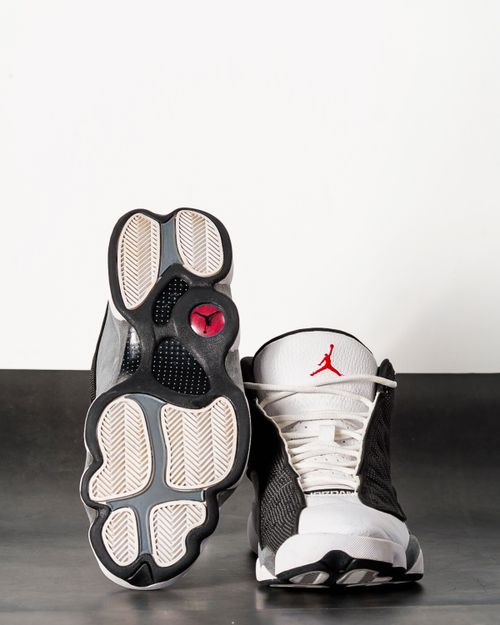 Free Front and bottom view of stylish retro sneakers in a studio setup, highlighting design and details. Stock Photo