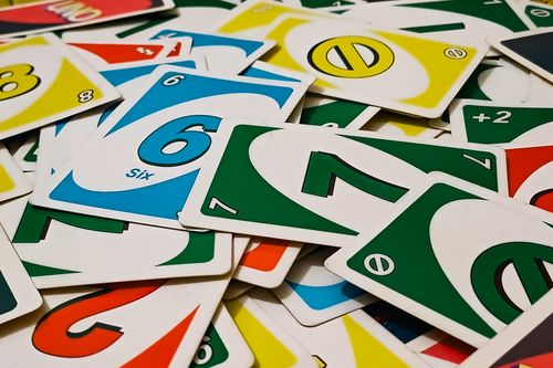 Free A vibrant display of Uno cards scattered in a random pile, showcasing various numbers and colors. Stock Photo