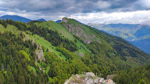 Scenic landscape of lush green mountains under dramatic clouds in Tetovo, North Macedonia.