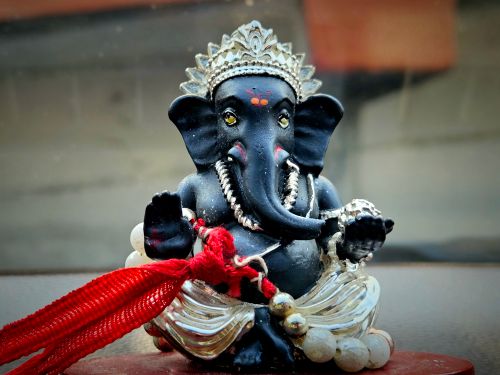 Free Detailed Ganesha statue with red accents, representing the Hindu god of wisdom and success. Stock Photo