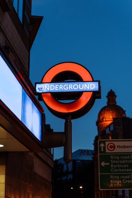 Free Captivating view of the London Underground sign illuminated against a twilight sky. Stock Photo