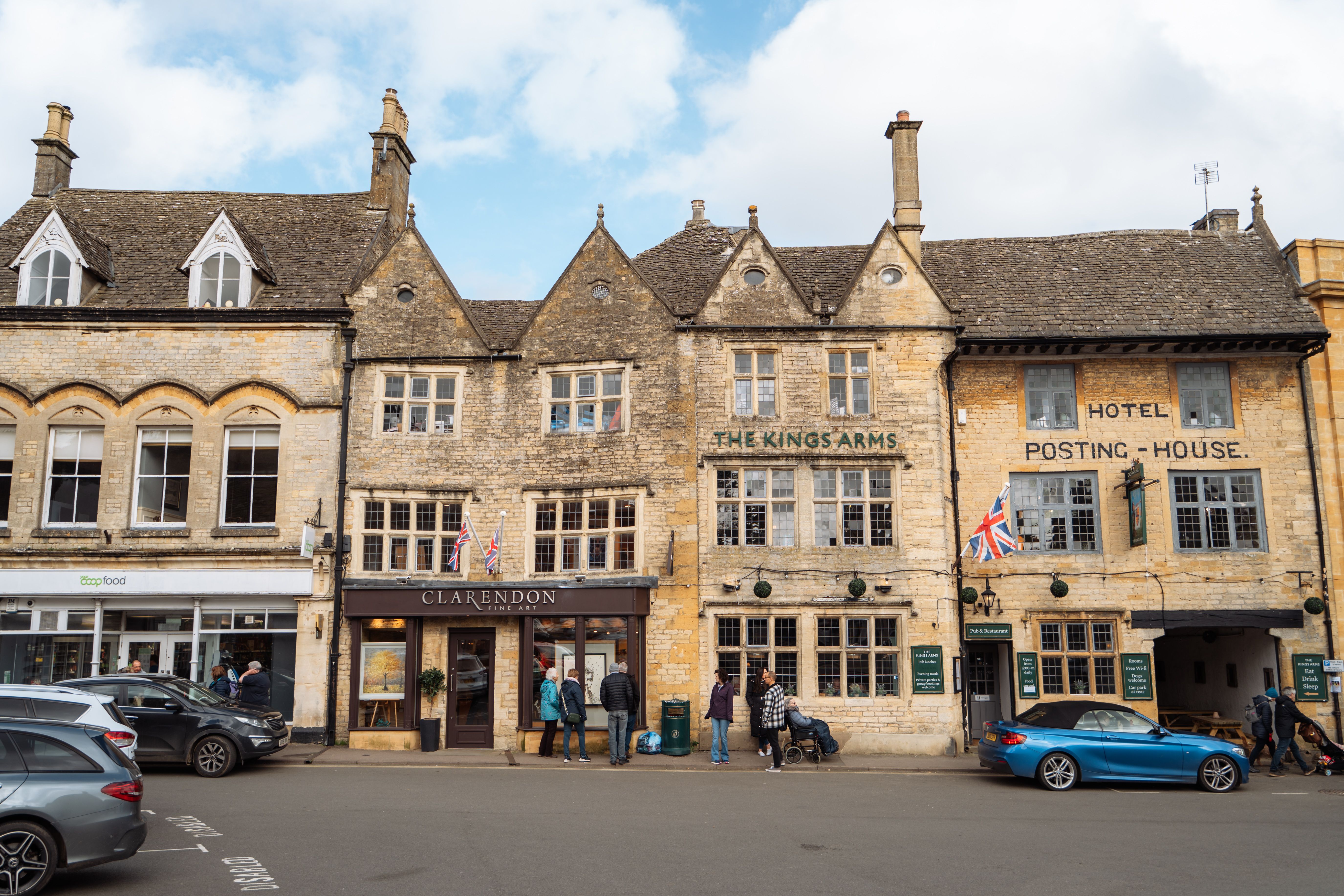 Quintessential English street with historic stone buildings in the Cotswolds, England, capturing traditional charm.