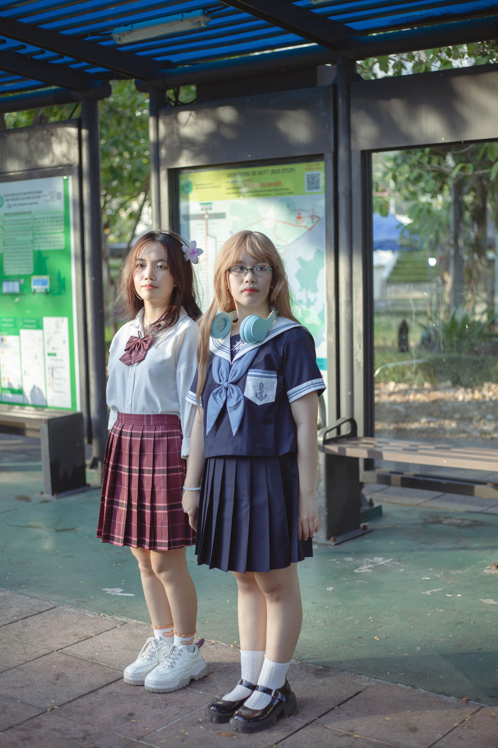 Two Girls in School Uniforms Holding Hands Outdoors · Free Stock Photo