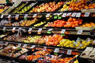 Fresh fruit arranged on grocery shelves — photo by Magda Ehlers on Pexels