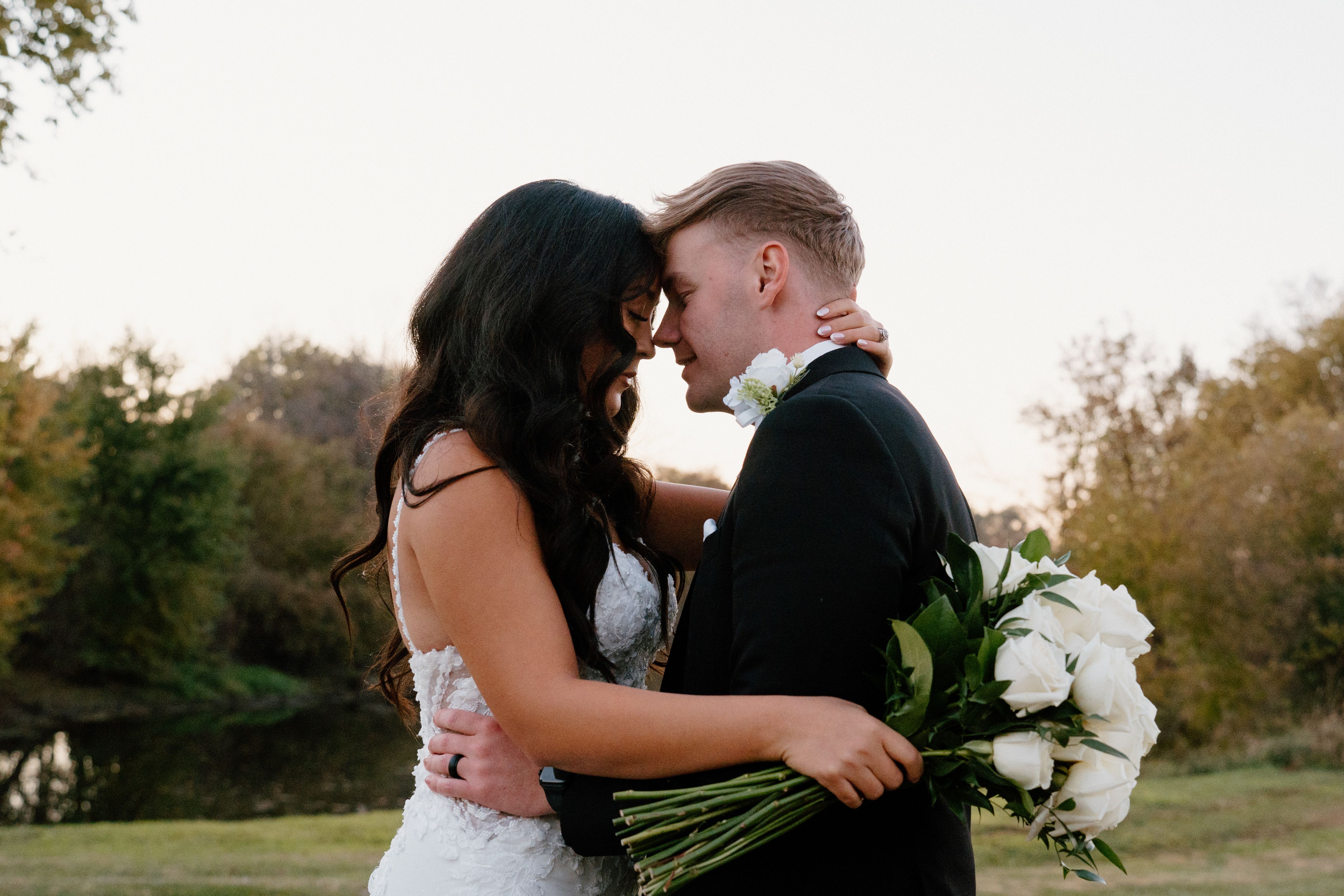 Romantic Wedding Couple Embracing Outdoors · Free Stock Photo
