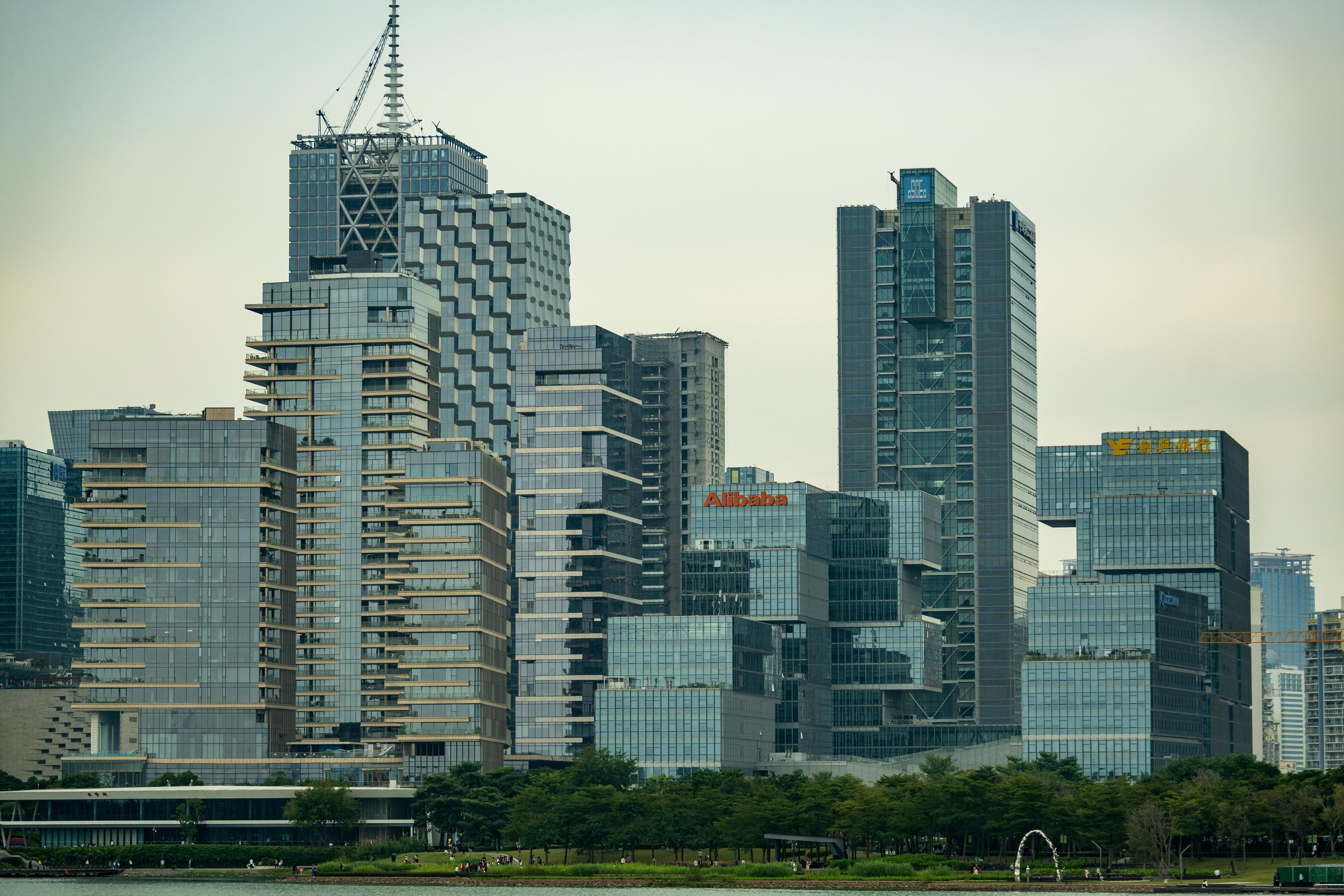 Skyline featuring modern skyscrapers with prominent logos of major companies.