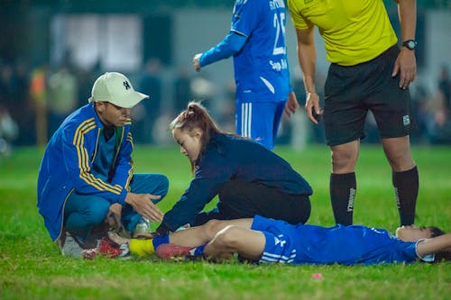 Free Medical team attends to an injured soccer player in Hà Nội, Vietnam. Stock Photo