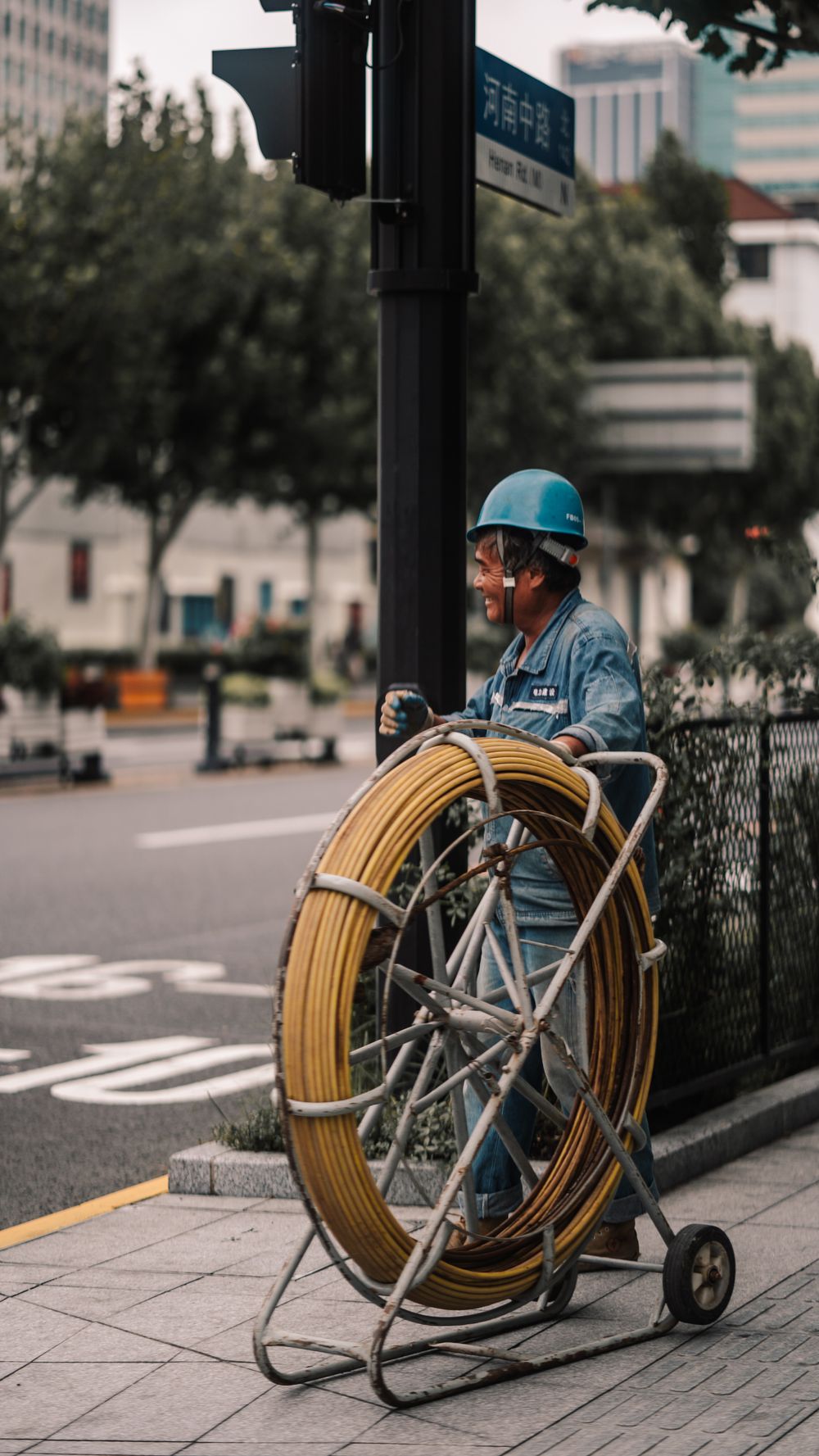 Technician with a push-rod reel used to feed an inspection line into an underground pipe