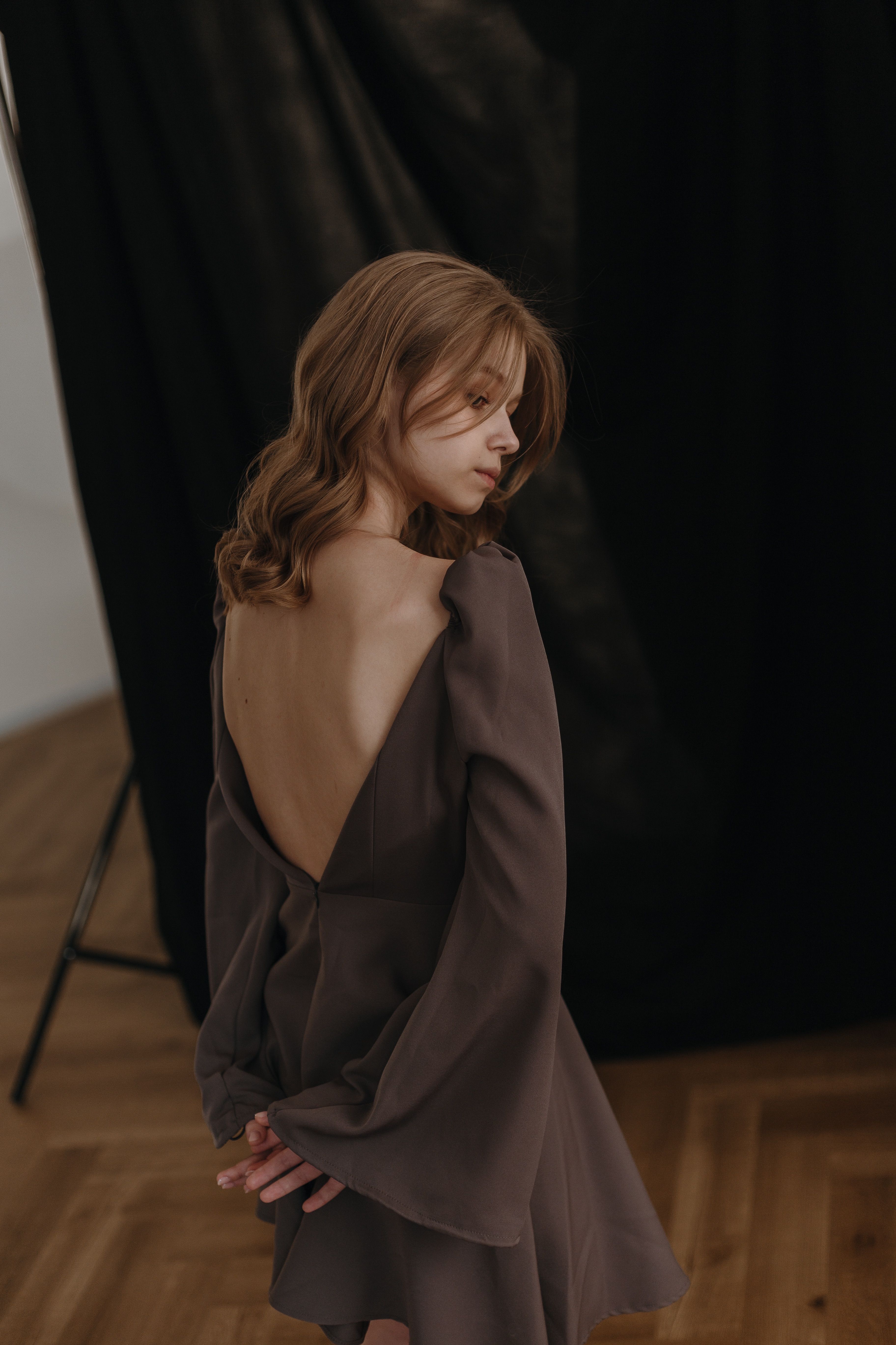 Elegant Woman Posing in Stylish Backless Dress · Free Stock Photo