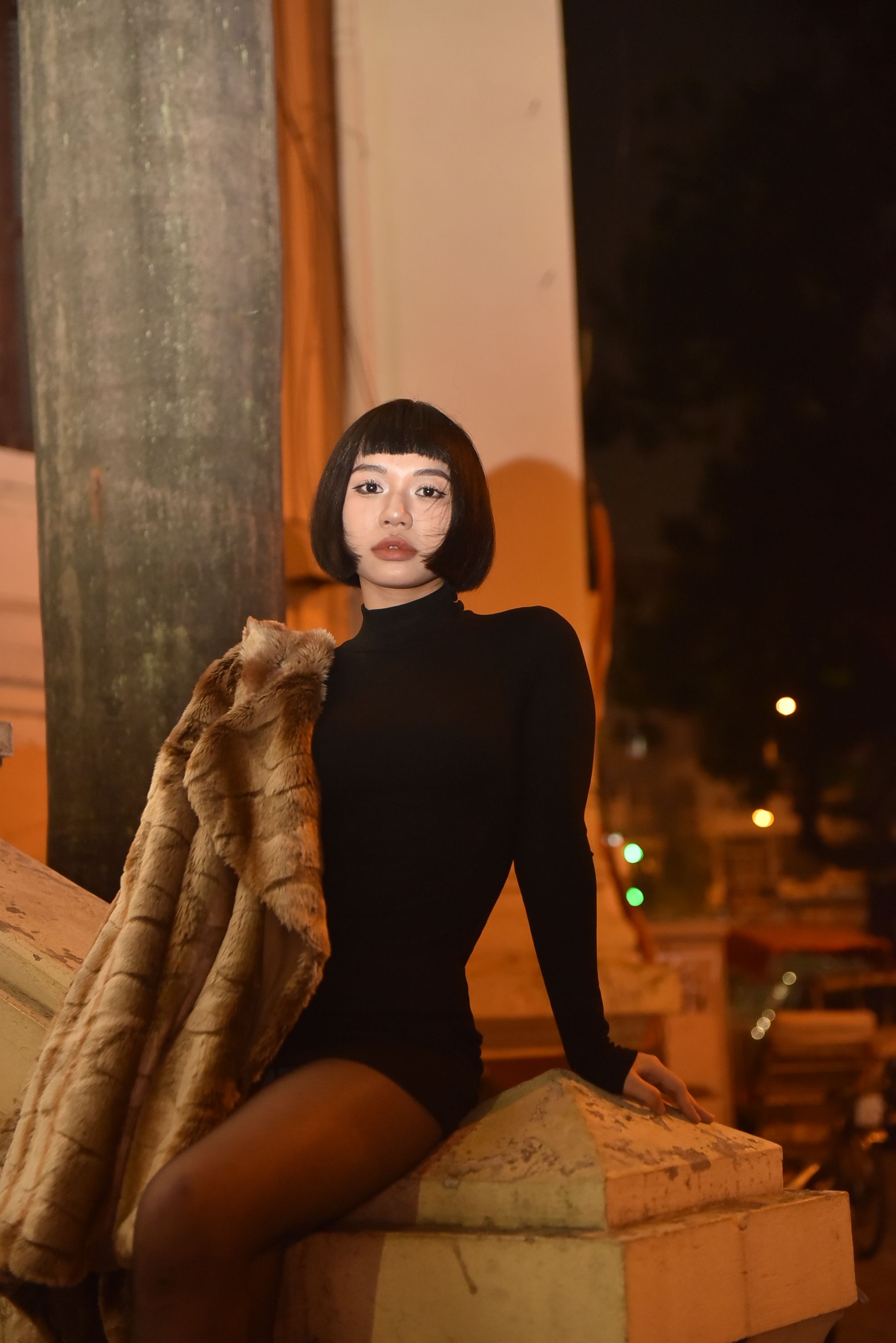 Stylish Woman Posing Outdoors at Night · Free Stock Photo