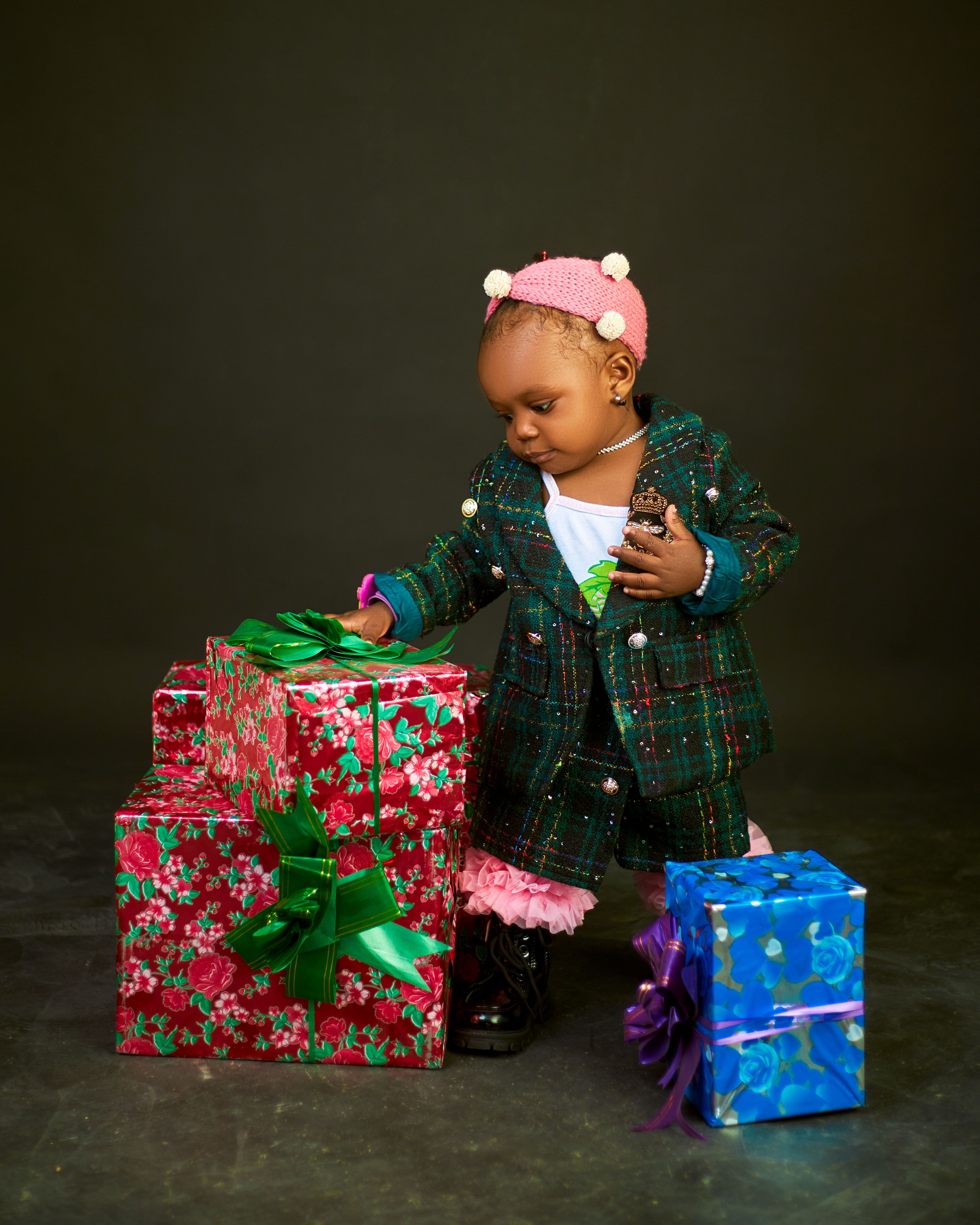 Adorable child opening gift boxes in a festive holiday setting. Perfect for celebrating special occasions.