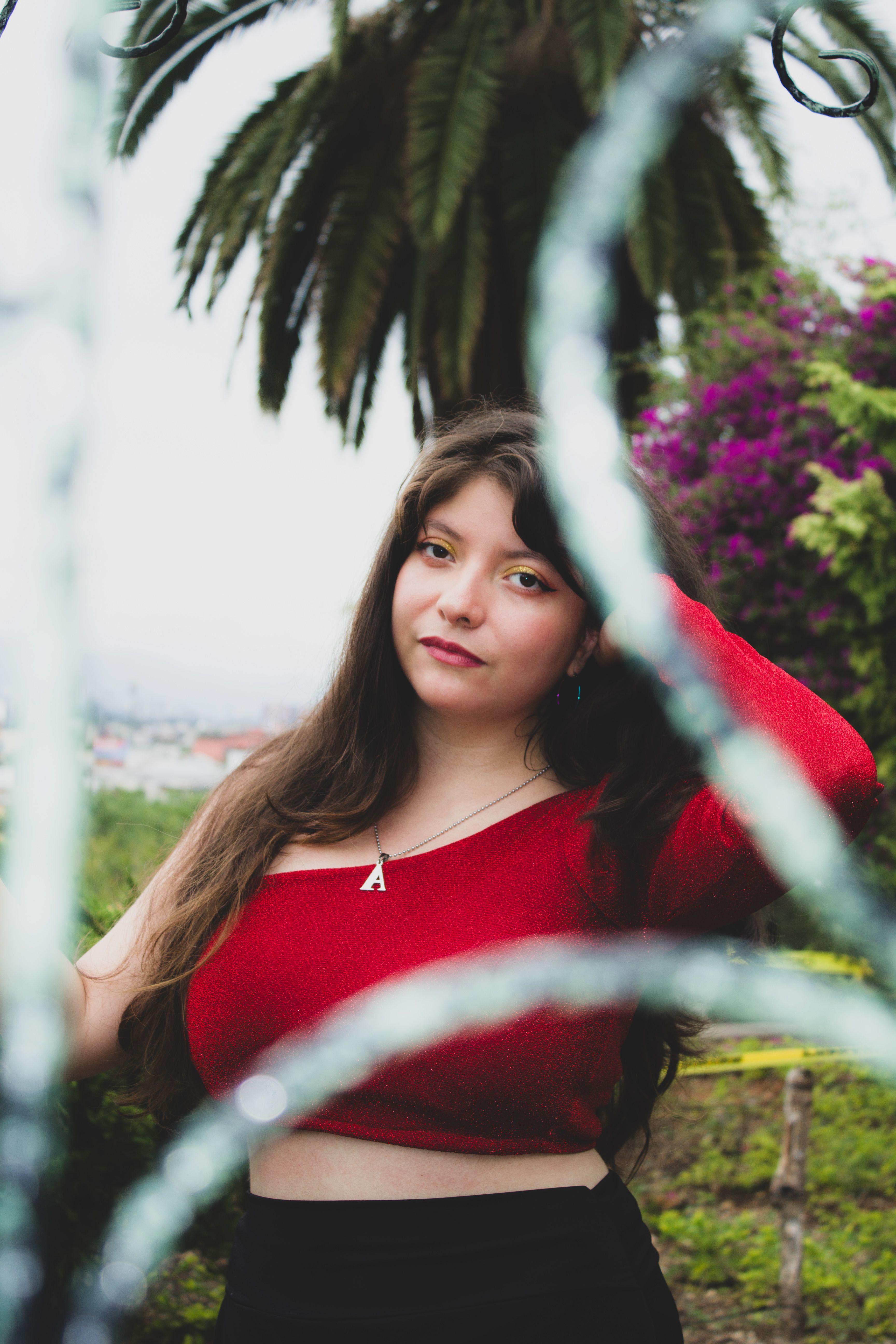 Young Woman in Red Top Outdoors with Palm Trees · Free Stock Photo
