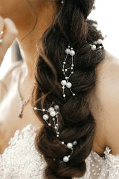 Close-up of an intricate bridal braid adorned with pearls, perfect for wedding inspiration.