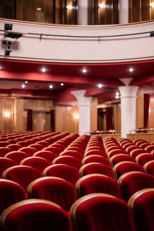 Free Capture the elegance of an empty theater with plush red seating and classic architectural details. Stock Photo