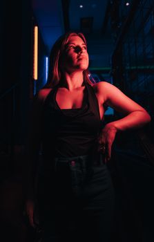 Dramatic portrait of a woman in neon lighting, evoking a moody and artistic atmosphere.