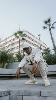 Fashionable person in streetwear posing in Casablanca's urban landscape.