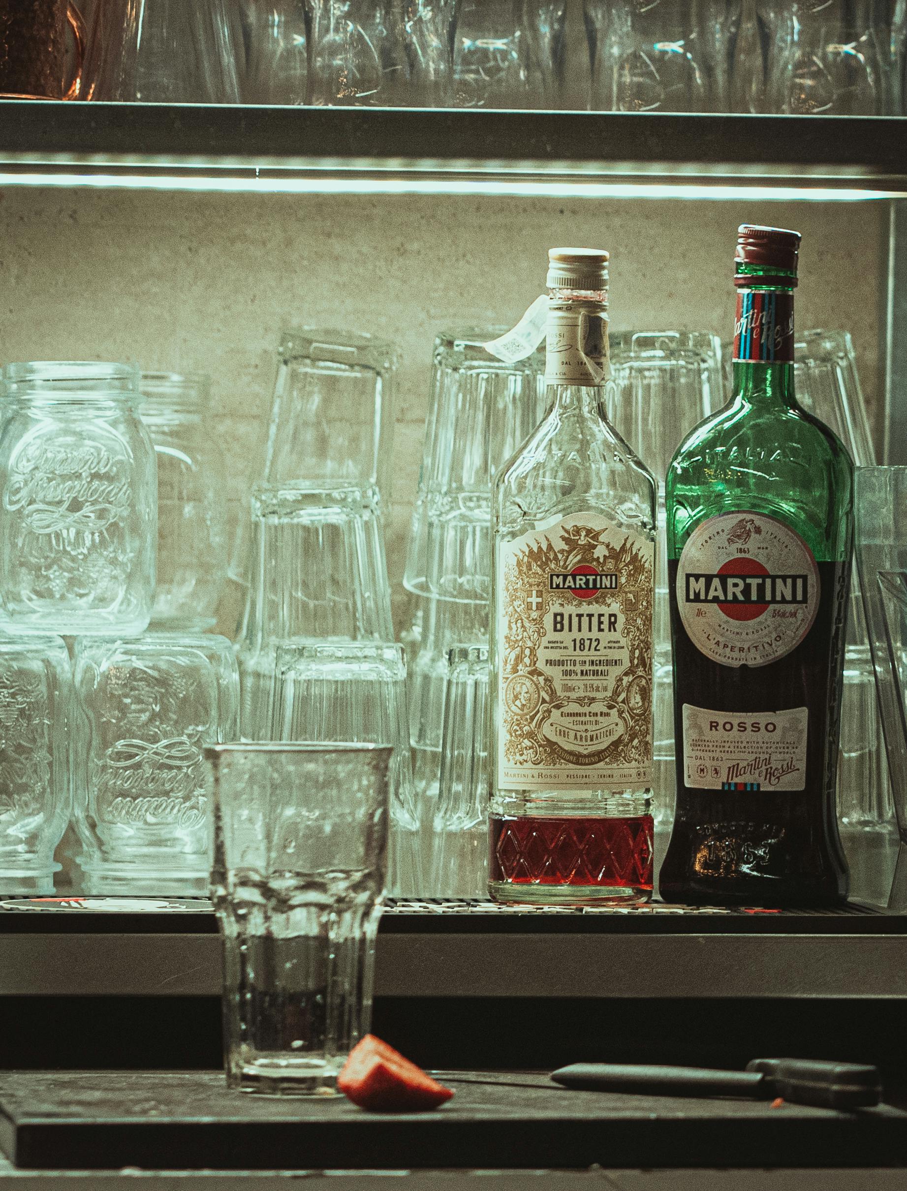 Chic bar scene featuring Martini bottles and glassware in Madrid, ideal for nightlife and decor themes.