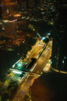 Aerial shot of South Jakarta's illuminated streets and skyscrapers at night.