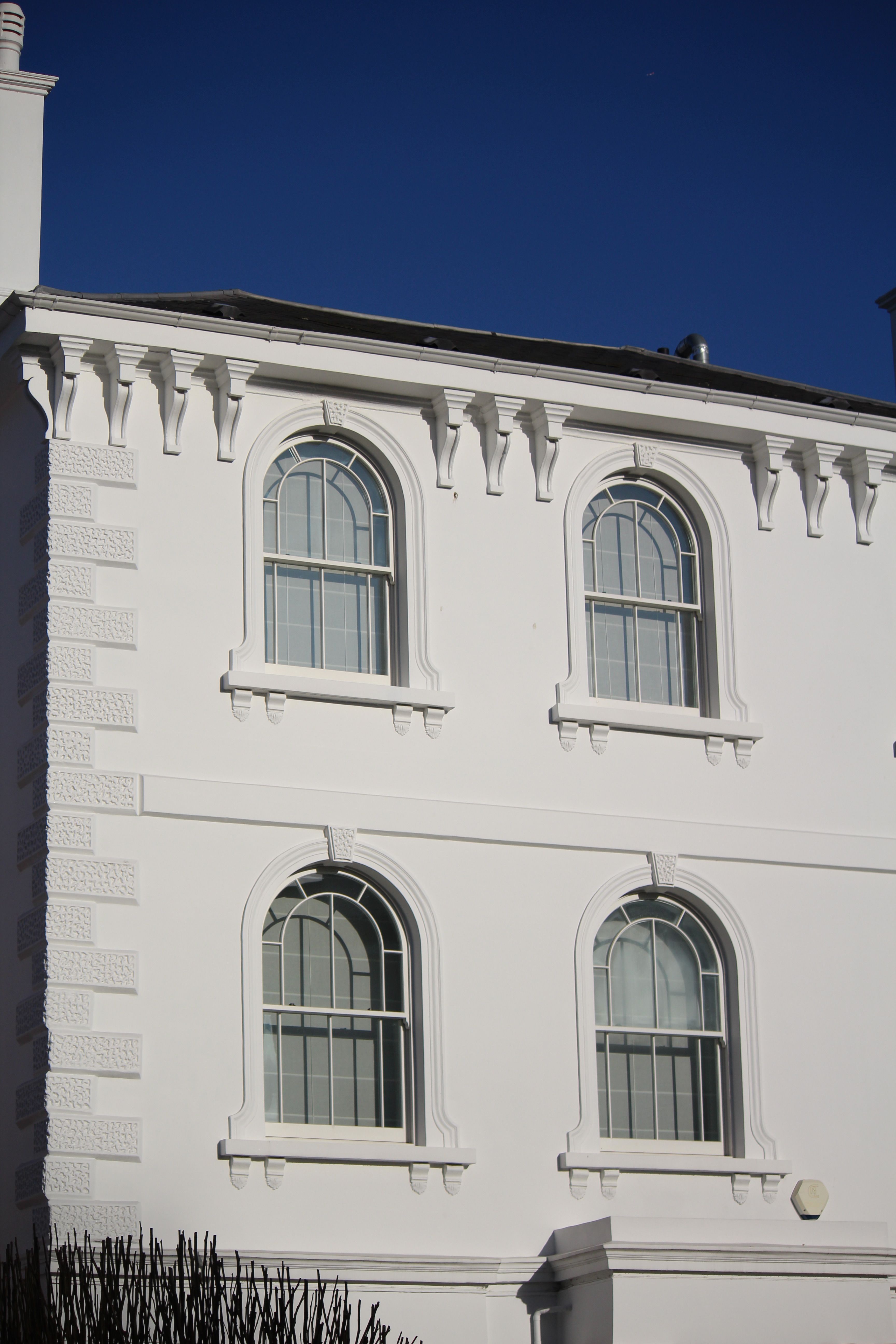 Elegant White Facade with Arched Windows · Free Stock Photo