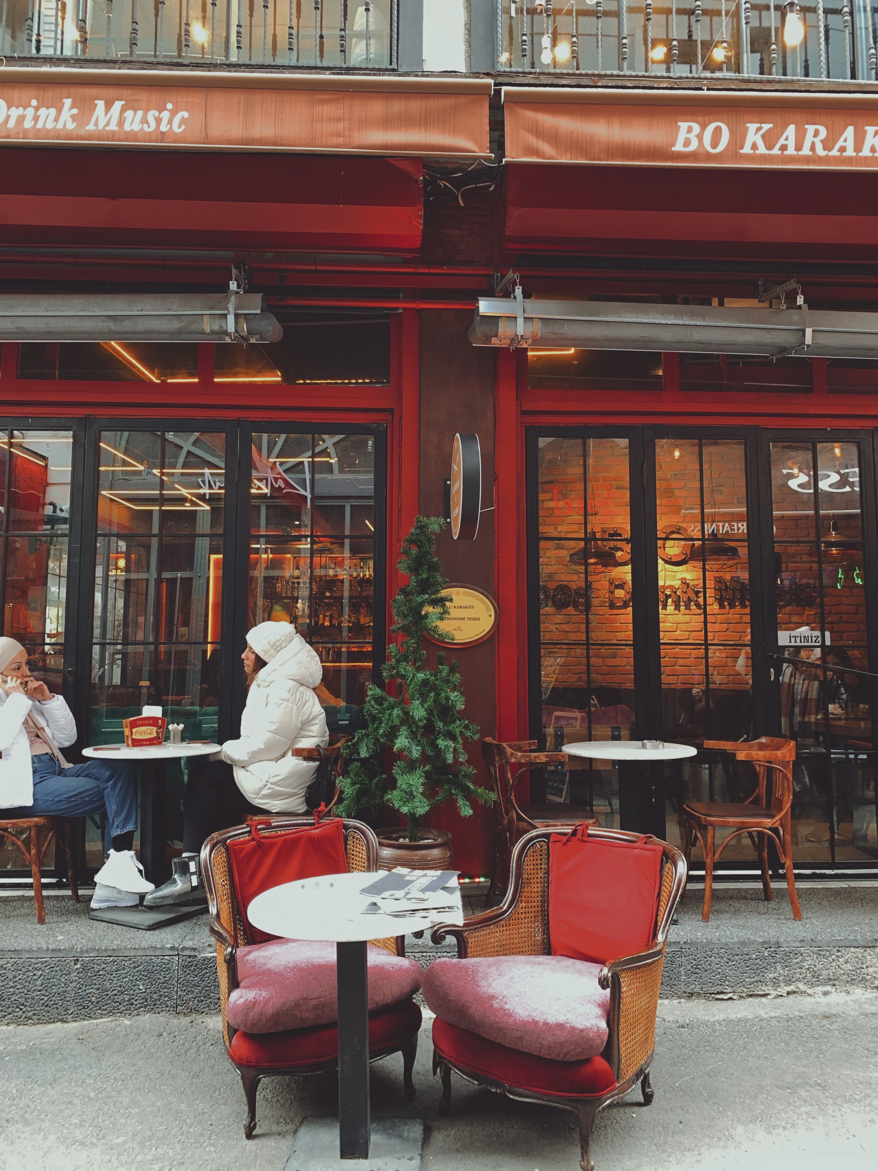 Cozy street cafe in Istanbul, showcasing outdoor tables and vibrant atmosphere.