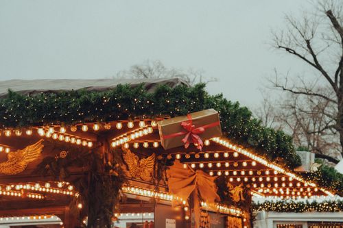 Free Christmas market stall adorned with lights and decorations, evoking holiday spirit. Stock Photo
