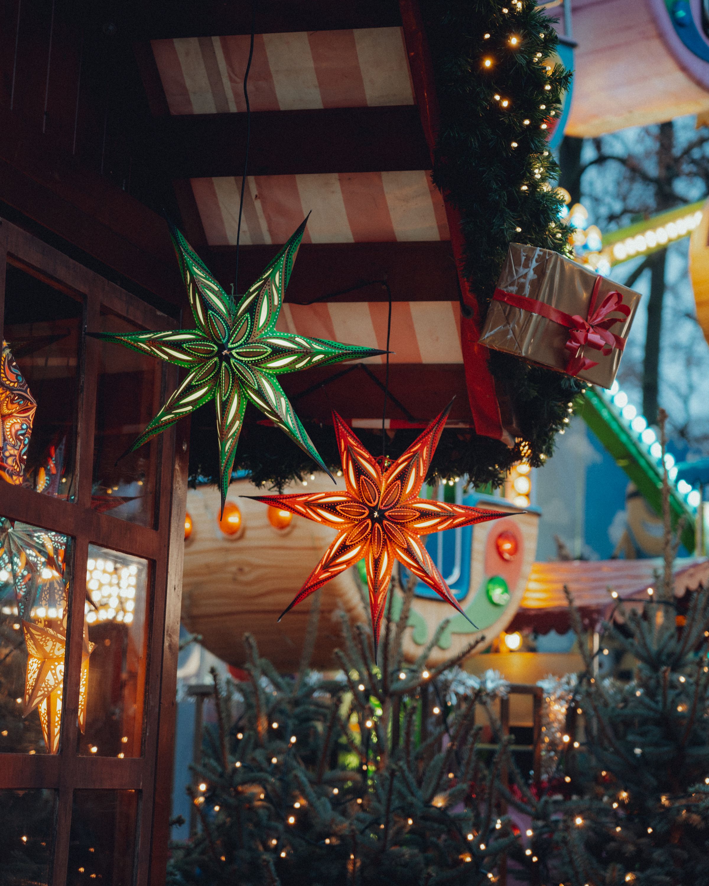Colorful star lights at a festive Christmas market. Perfect holiday decorations and atmosphere.