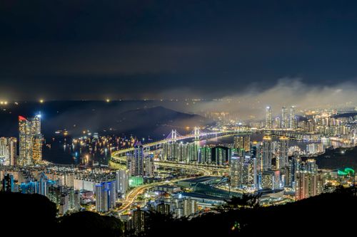 Free A breathtaking nighttime view of Busan's illuminated skyline and Gwangandaegyo Bridge. Stock Photo