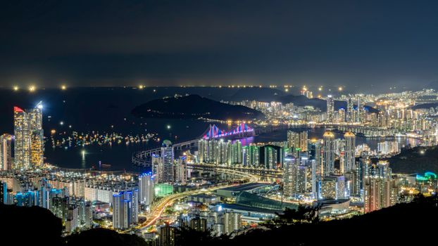 Stunning view of Busan's illuminated skyline and Gwangan Bridge at night in South Korea.