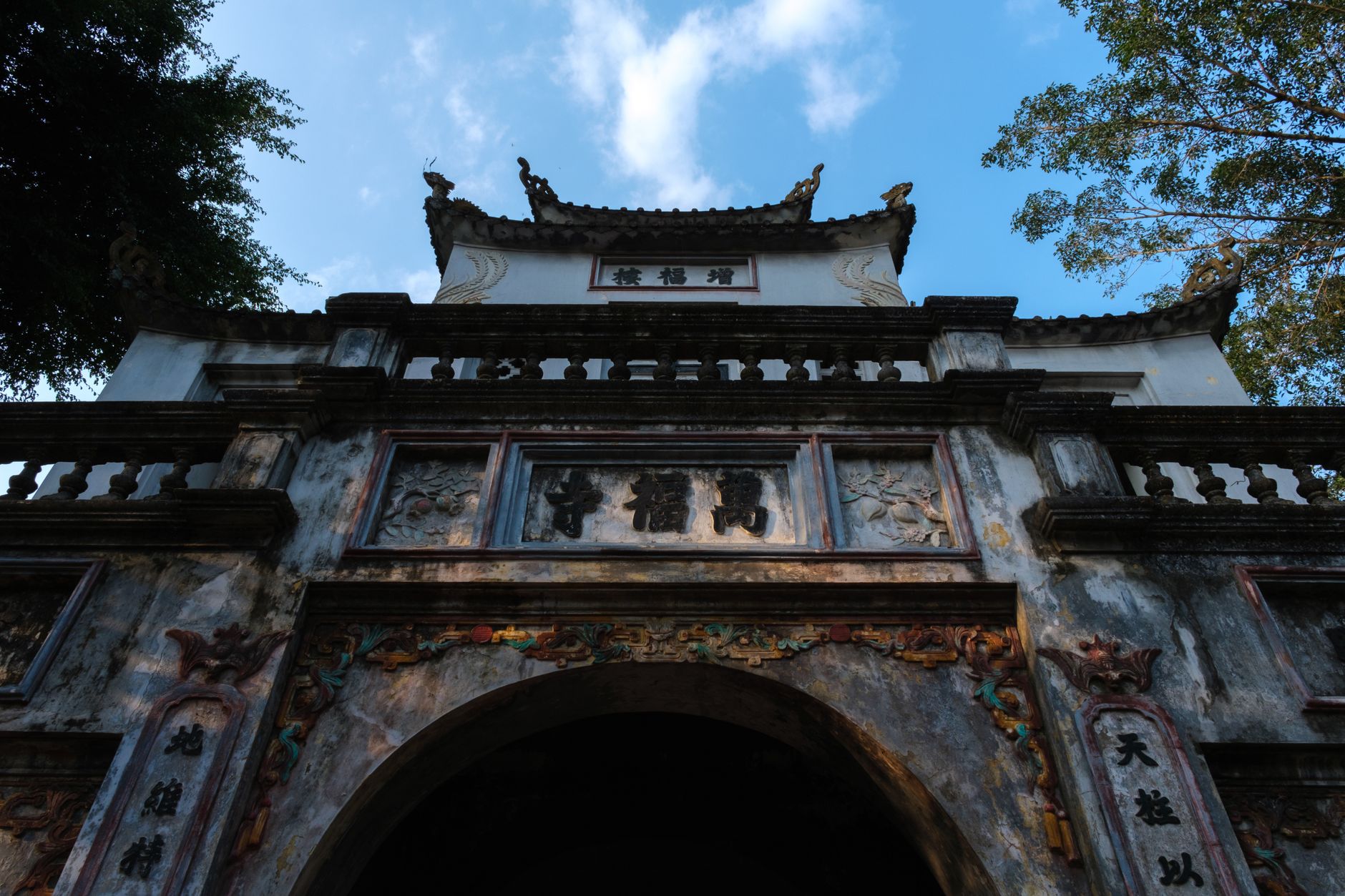 Ancient architectural gate of a temple in Hanoi, showcasing traditional Vietnamese design.