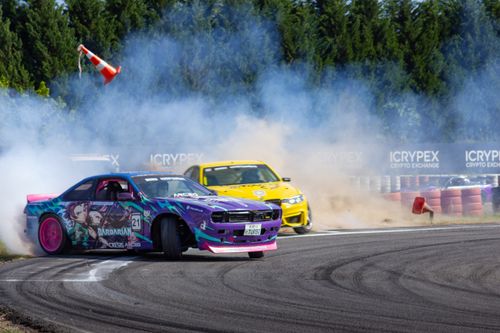 Free Dynamic drift car race with vivid colors and smoke on a sunny track, showcasing speed and style. Stock Photo