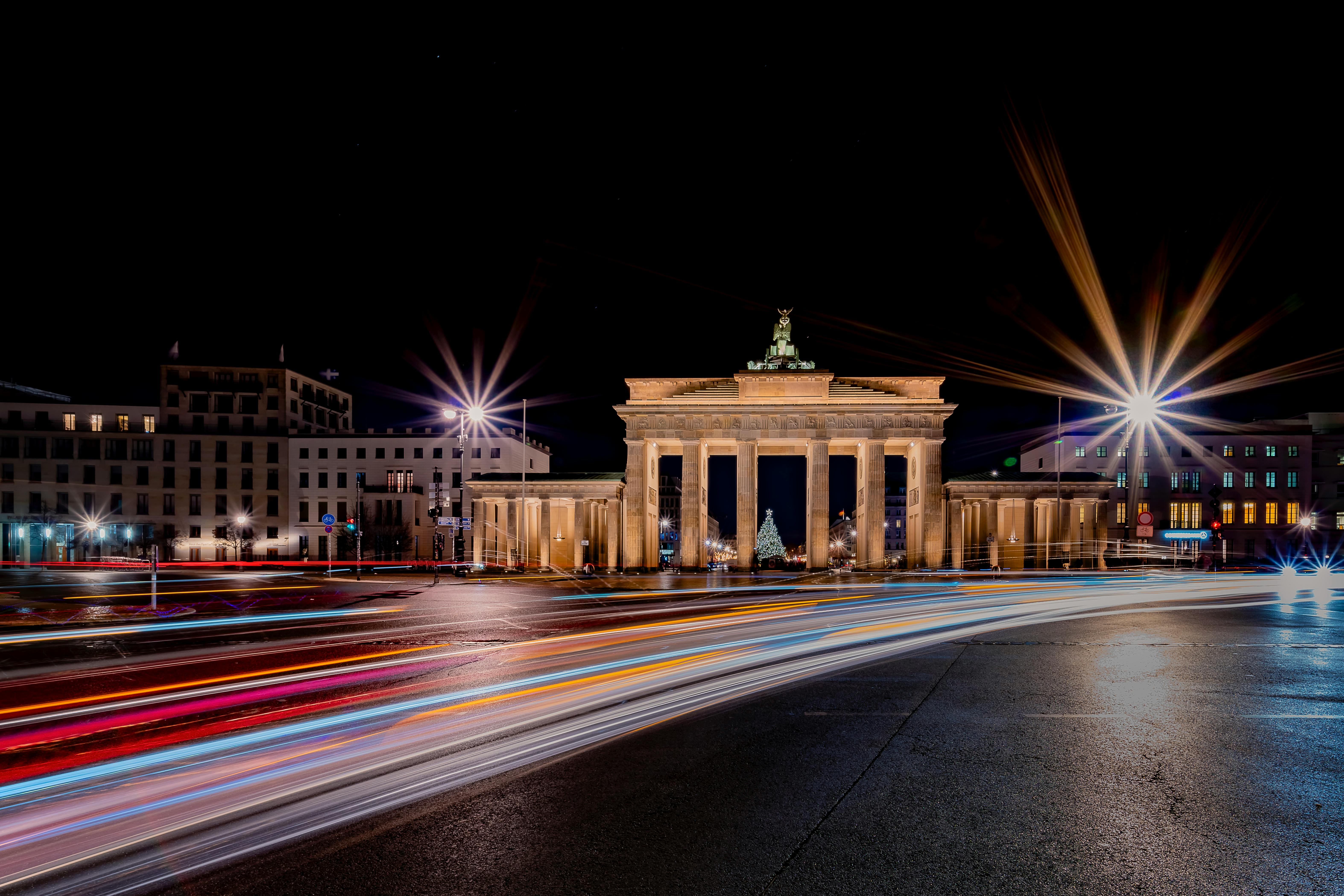 brandenburg gate at night with light trails in berlin