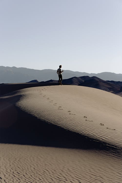 Man Standing on Sand dunes 