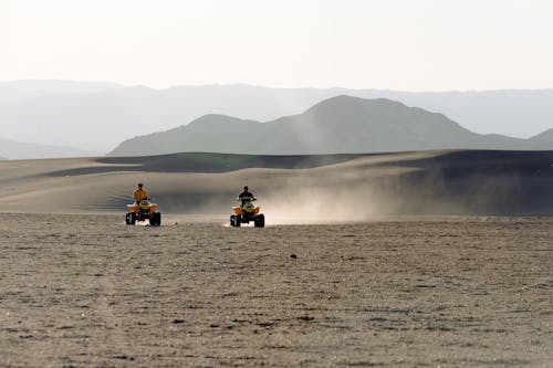 Two People Riding Atv on Desert