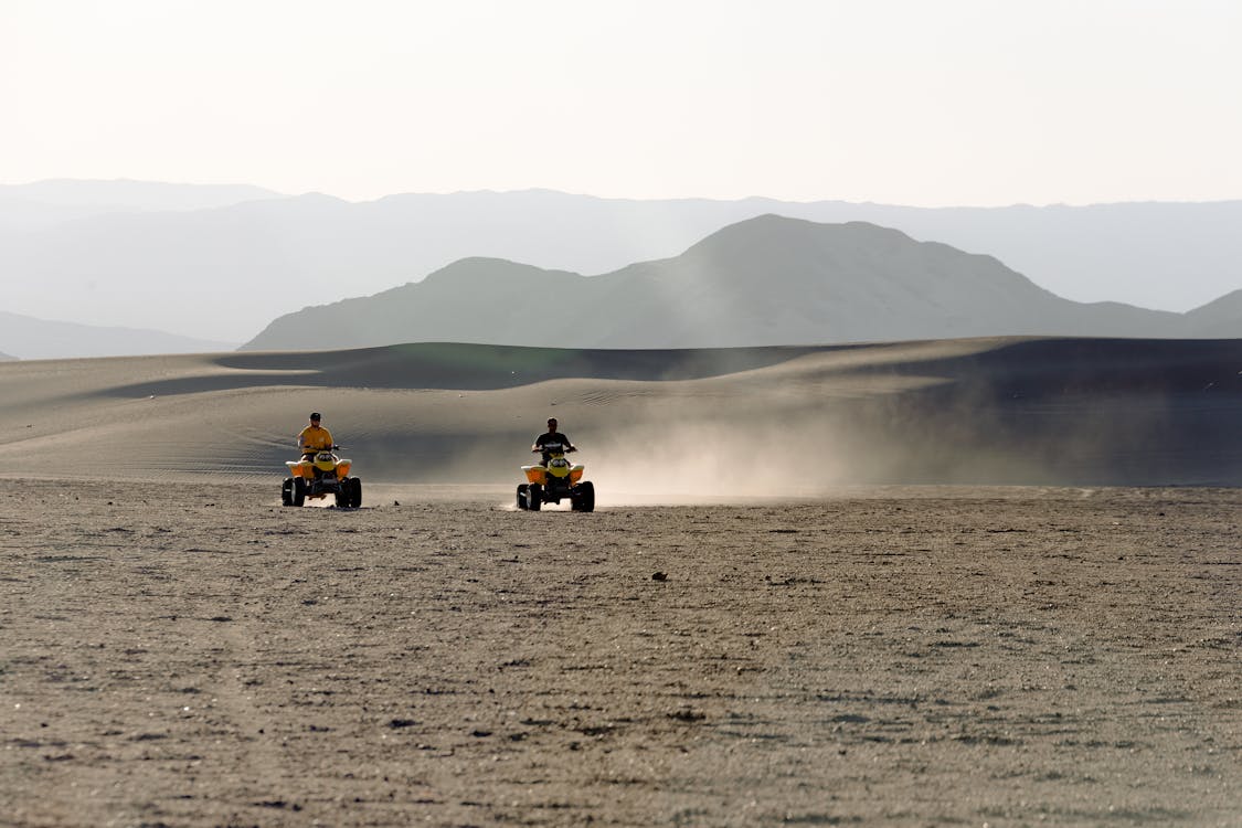 Free Two People Riding Atv on Desert Stock Photo