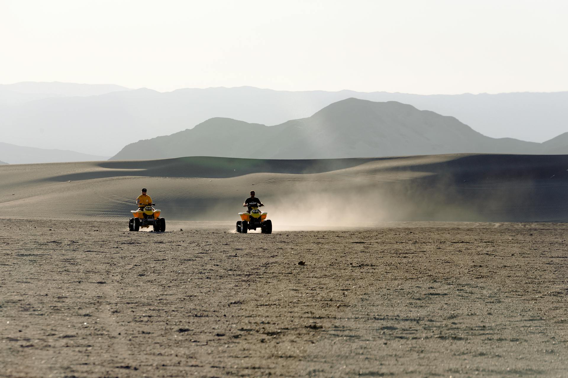 Two People Riding Atv on Desert