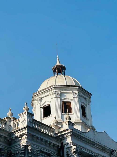 Free A beautiful white domed building in Rangpur, Bangladesh, showcasing ancient architecture against a clear blue sky. Stock Photo