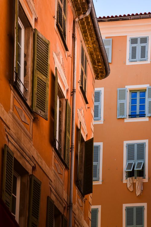 Free Colorful shuttered windows and rustic facades in Provence, France, daytime scene. Stock Photo
