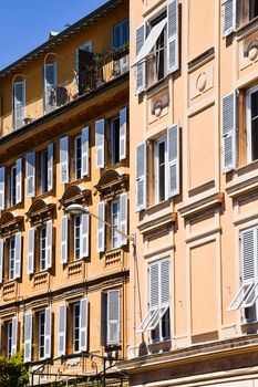 Elegant sunlit buildings with balconies in Nice, France, showcasing classic architectural style.